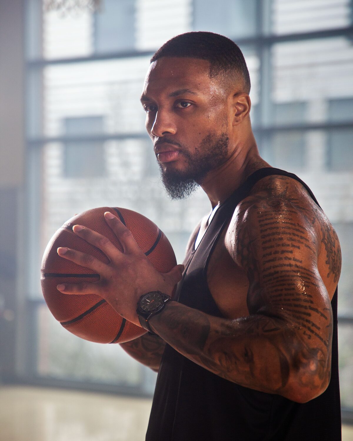 Damian Lillard holding a basketball, wearing a Tissot