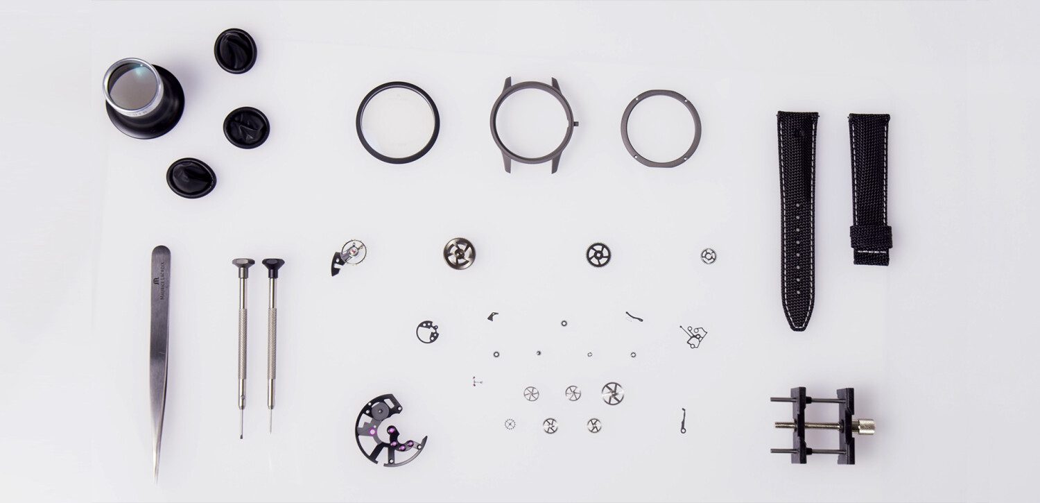 A Maurice Lacroix timepiece dismantled for servicing, with the watchmaker's tools